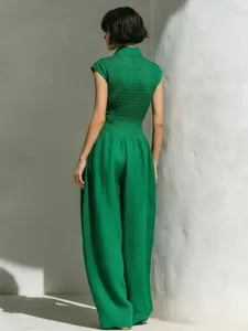 Detailed back view of an elegant emerald green sleeveless jumpsuit with smocked waist.