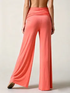 Back view of coral pink wide-leg yoga pants showing smooth drape and relaxed fit style