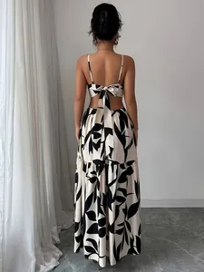 Elegant rear view of a floral print backless maxi dress featuring a stylish bow detail