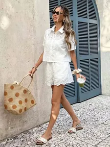 Fashionable white eyelet lace two-piece set featuring hollow crochet floral details