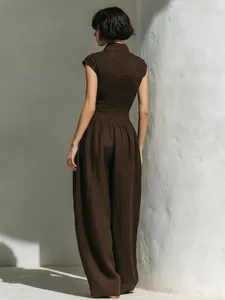 Back view detail of brown sleeveless dress with smocked bodice and wide-leg design