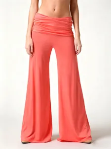 High-quality detail of coral pink wide leg yoga pants featuring a stylish ruched waist
