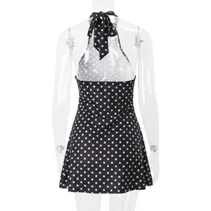Detailed back view of a trendy black and white polka dot halter neck backless mini dress