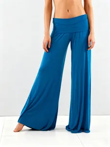 High-quality detail view of solid teal wide-leg yoga pants featuring a comfortable fold-over waist