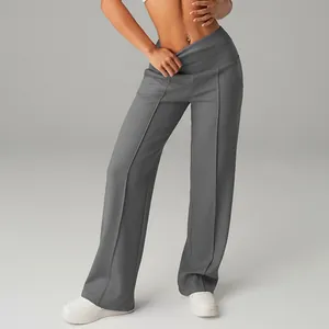 High-waisted wide-leg grey yoga pants for women shown in a full-length detail shot.