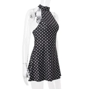 Side view detail of a classic black and white polka dot halter neck sleeveless mini dress