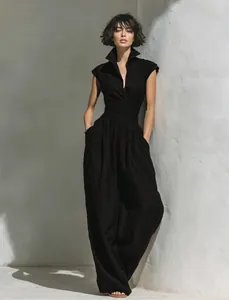 Elegant black sleeveless V-neck maxi dress with cinched waist and wide silhouette.