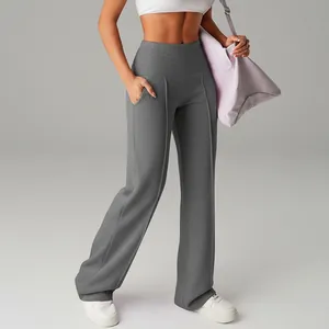 Close-up detail of grey high-waisted wide-leg yoga pants with pockets for fitness.