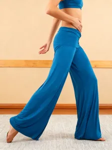 Side view of flowing blue wide-leg yoga pants showing excellent fabric drape and flare