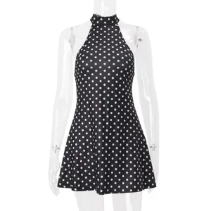 Front detail of a black and white polka dot halter neck sleeveless slim waist dress