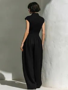 Elegant black sleeveless jumpsuit featuring a textured smocked bodice and wide-leg trousers