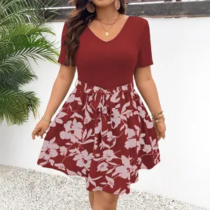Close-up detail of a plus-size V-neck patchwork dress with floral print and waist tie