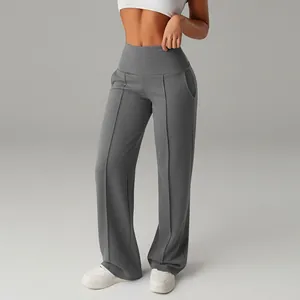 Detail view of grey high-waisted wide-leg yoga pants showing slimming athletic fit