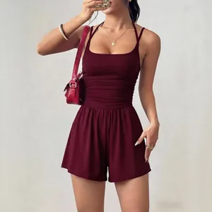 Stylish sleeveless burgundy bandeau romper featuring ruched waist and wide-leg shorts