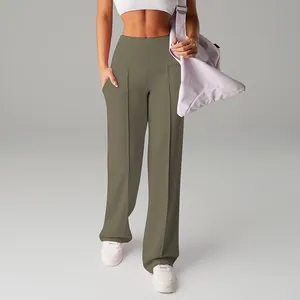 Detail view of women's high-waisted wide-leg sports pants in olive green with pleated front.