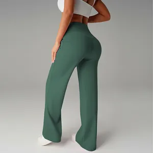 Detail view of high-waisted green wide-leg flare athletic yoga pants for women