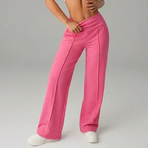 Detail of pink high-waisted wide-leg sports pants showing the flowy fit.