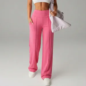 Detailed view of pink high-waisted wide-leg yoga pants for a comfortable gym look