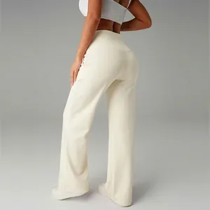 Close-up back view of high-waisted cream wide-leg yoga pants showing the slimming fit