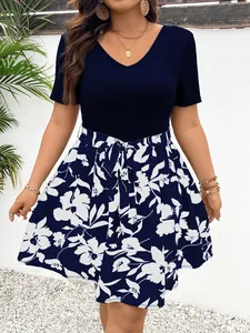 Detailed view of plus size V-neck patchwork dress with navy floral print skirt