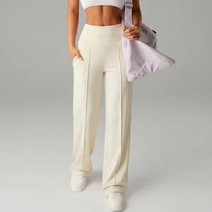 Close-up detail of cream high-waisted wide-leg athletic pants with vertical seam design