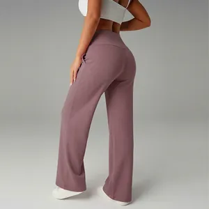 Close-up view of high-waisted purple wide-leg sports pants shown from a rear side angle