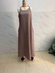 Detailed view of a minimalist sleeveless solid color mauve cami maxi dress on a mannequin