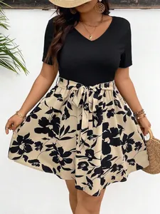 Close-up detail of a plus size V-neck dress with floral print skirt and waist tie-belt