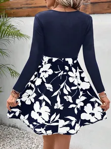 Back view of a spliced floral print dress with navy long sleeves and white flowers.