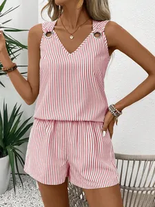 Detail view of pink striped V-neck top with metal grommets and high waist shorts