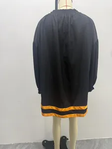 Back view of black puff sleeve baby doll dress with yellow hem stripes on mannequin