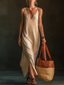 A stylish beige V-neck maxi dress with a high side slit, perfect for a bohemian summer look.