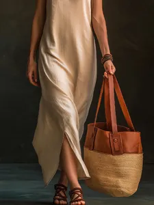 Detailed view of the side slit on a beige sleeveless V-neck vacation style maxi dress