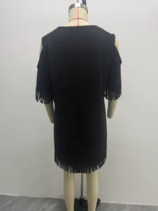 Back view of a black suede dress featuring cold-shoulder cutouts and fringe tassel trim