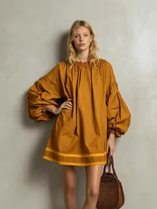 Mustard yellow loose puff sleeve babydoll dress with color-block hem and woven handbag