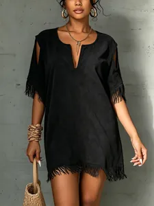 Close-up of black suede dress with V-neck, cold shoulders and fringe details