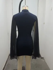 Back view of navy ribbed bodycon dress featuring sheer black chiffon cape sleeves