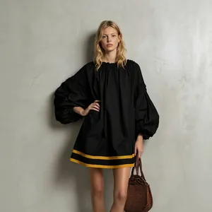 Resort style black loose babydoll mini dress with puff sleeves and yellow stripes
