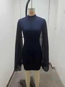 Detailed view of dark bodycon dress featuring ribbed fabric and sheer chiffon cape sleeves