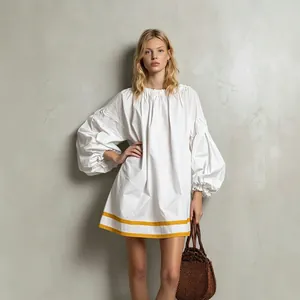 Relaxed white puff sleeve mini dress featuring yellow stripe trim for summer holidays
