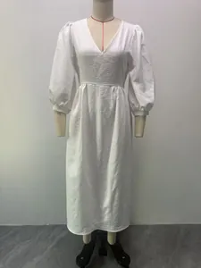 Front view of white V-neck dress with puff sleeves on a mannequin, showcasing A-line silhouette