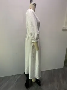 Detailed side view of white V-neck midi dress with puff sleeves on a professional mannequin