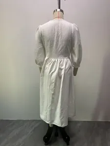 Detailed back view of a white V-neck puff sleeve A-line midi dress with textured fabric