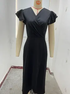 Close-up of elegant black V-neck dress with ruffle sleeves and irregular hemline detail.