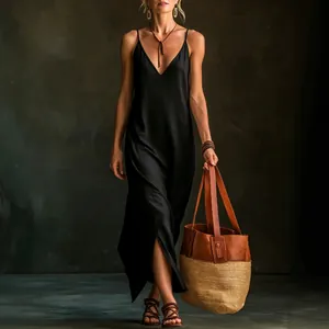 Elegant black V-neck camisole maxi dress with side slit for summer vacation style.