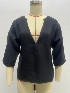 Detailed view of a casual black women's blouse with V-neck displayed on a mannequin