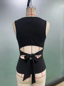 Detailed back view of black sleeveless tie-up tank top with cutout and bow on mannequin