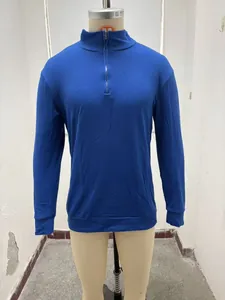 Close-up of the quarter-zip collar and blue knitted fabric of the men's polo shirt