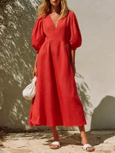 Elegant red A-line midi dress with deep V-neck and stylish puff sleeves for vacation