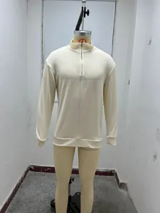 Close-up detail of a cream long-sleeve quarter-zip men's knitted pullover on mannequin